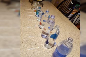 Woman Buys 8 Bottles Of Water, Keep Your Eyes On The White Strips In Front Of Them
